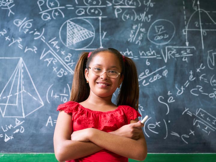 Portrait Happy Girl Resolving Complex Math Problem On Blackboard